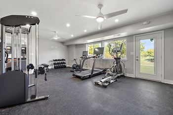 A spacious home gym with a variety of exercise equipment.